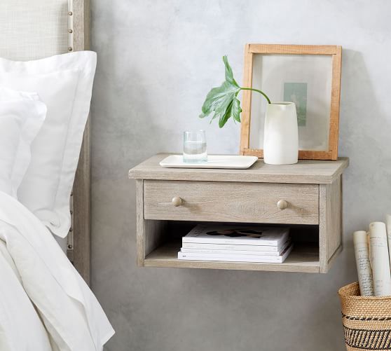 floating nightstand on wall next to bed