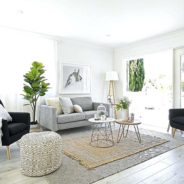 bright living area with large rug seating and side tables