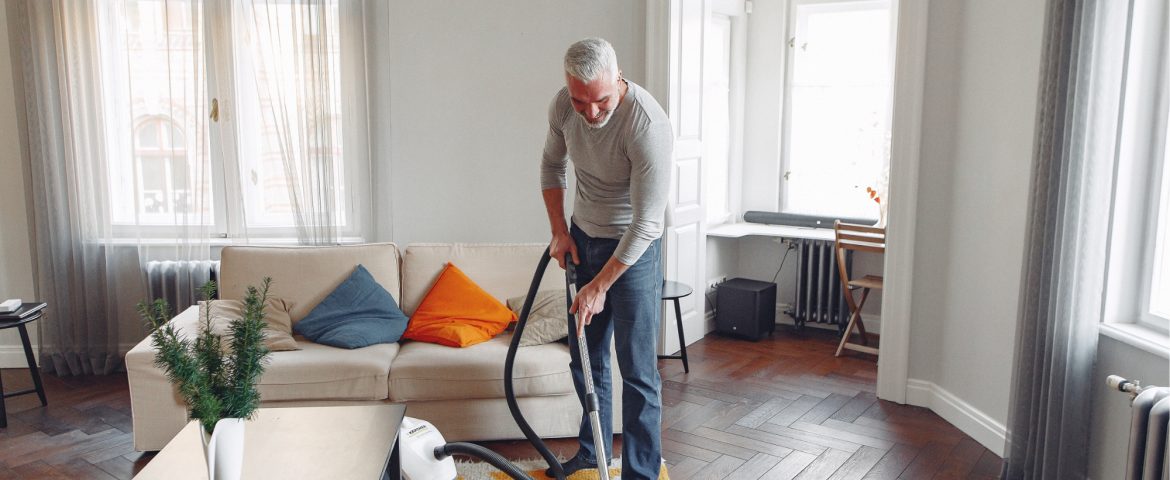 Senior vacuuming