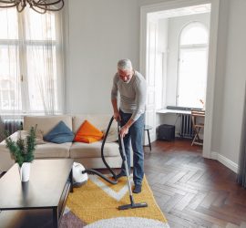 Senior vacuuming