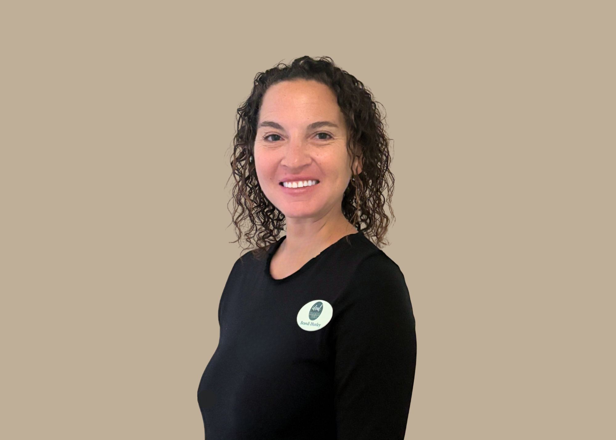 Social media specialist Brandi Hunley in black shirt and name tag